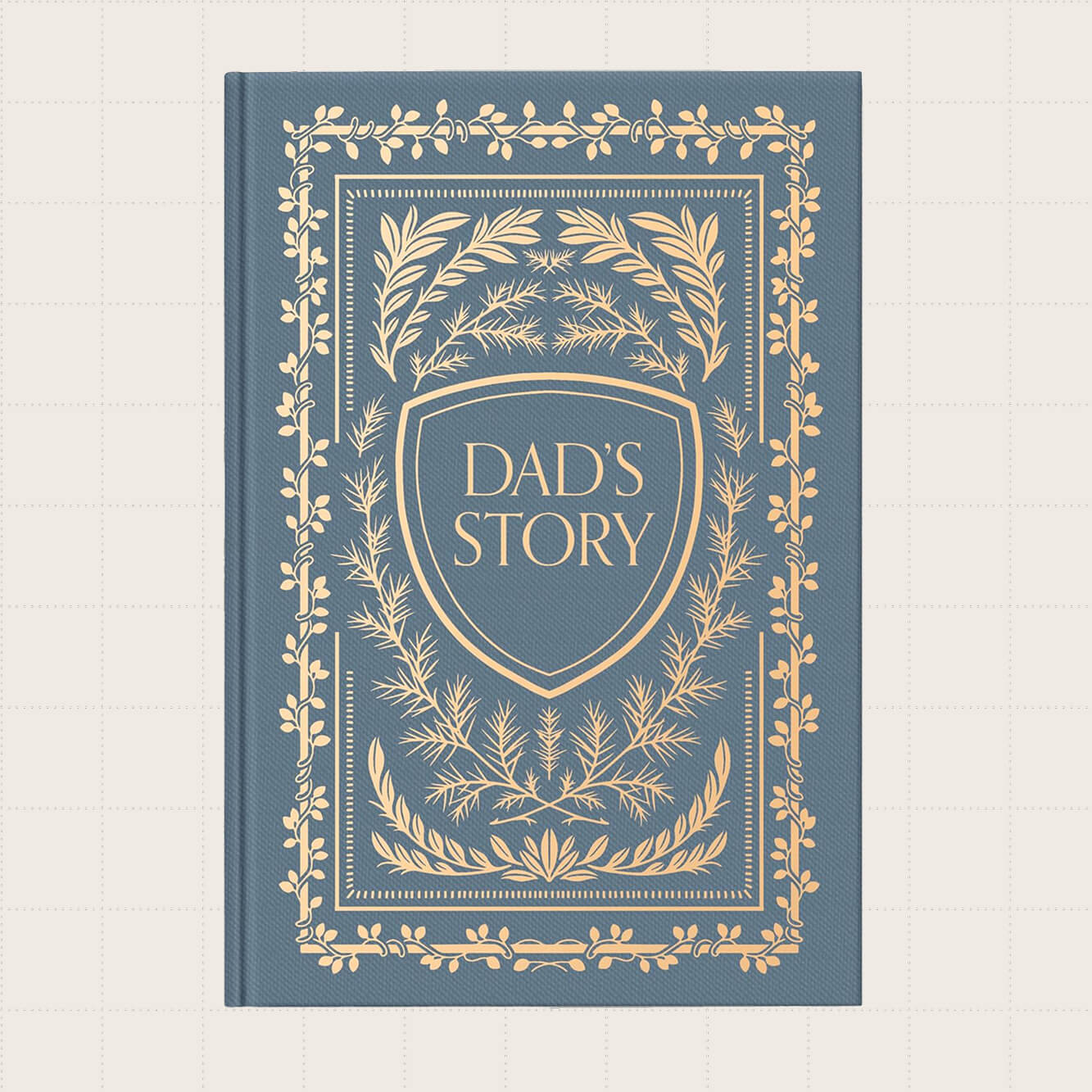 A dusty blue journal with a gold design on the cover that says "Dad's Story."