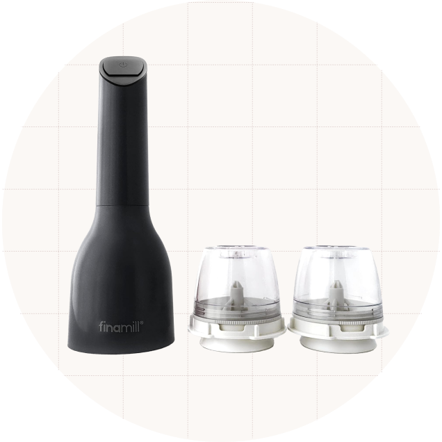 The FinaMill Battery-Operated Spice Grinder in black shown with its two included spice pods.