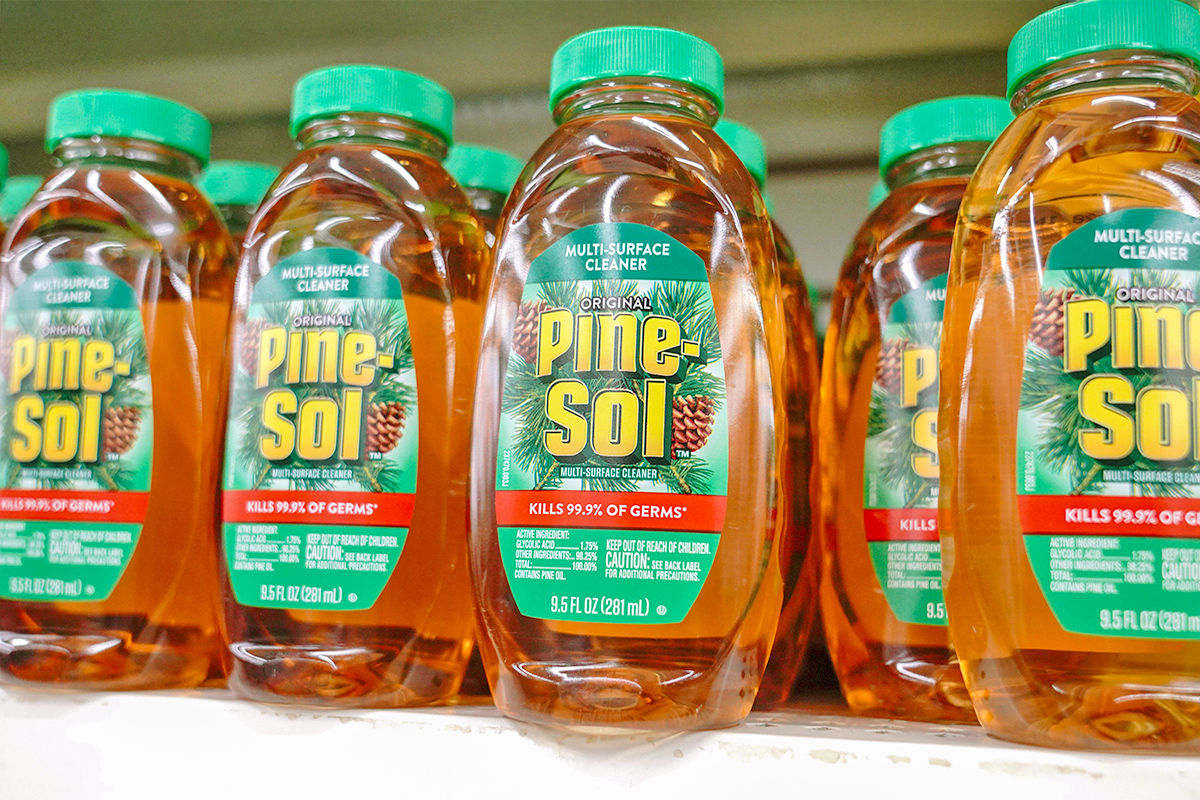 Many bottles of Original Pine-Sol on a shelf in a store.