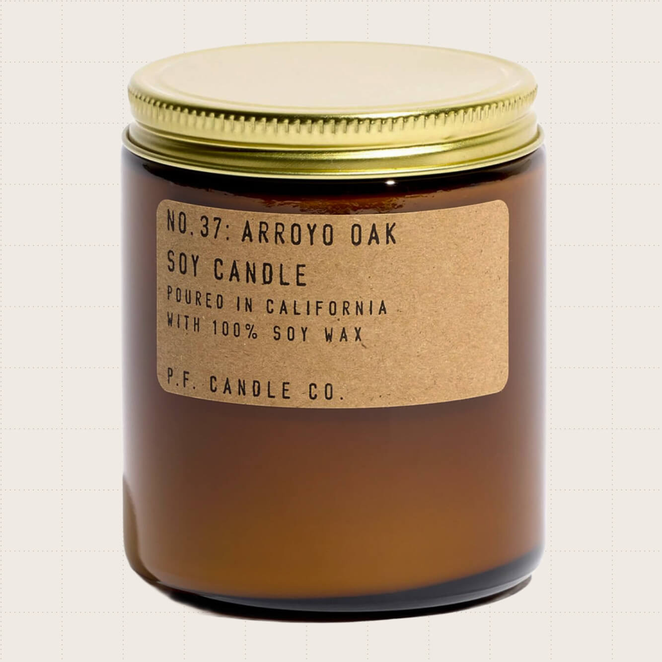 P.F. Candle Co. Arroyo Oak Classic Standard Scented Soy Wax Candle in an amber glass jar with a gold-colored lid.