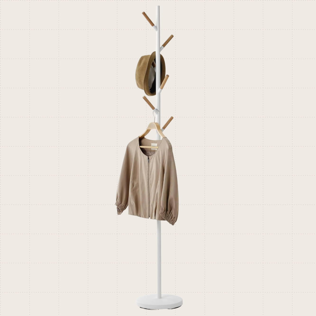 Yamazaki Home Freestanding Coat Rack Stand. The stand has a white finish with natural wood-colored pegs.